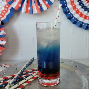 Red, White, and Blue Cocktail on a silver platter next to patriotic straws