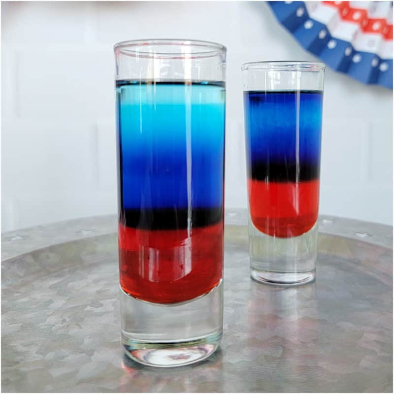 Red white and blue cocktail shots on a silver platter