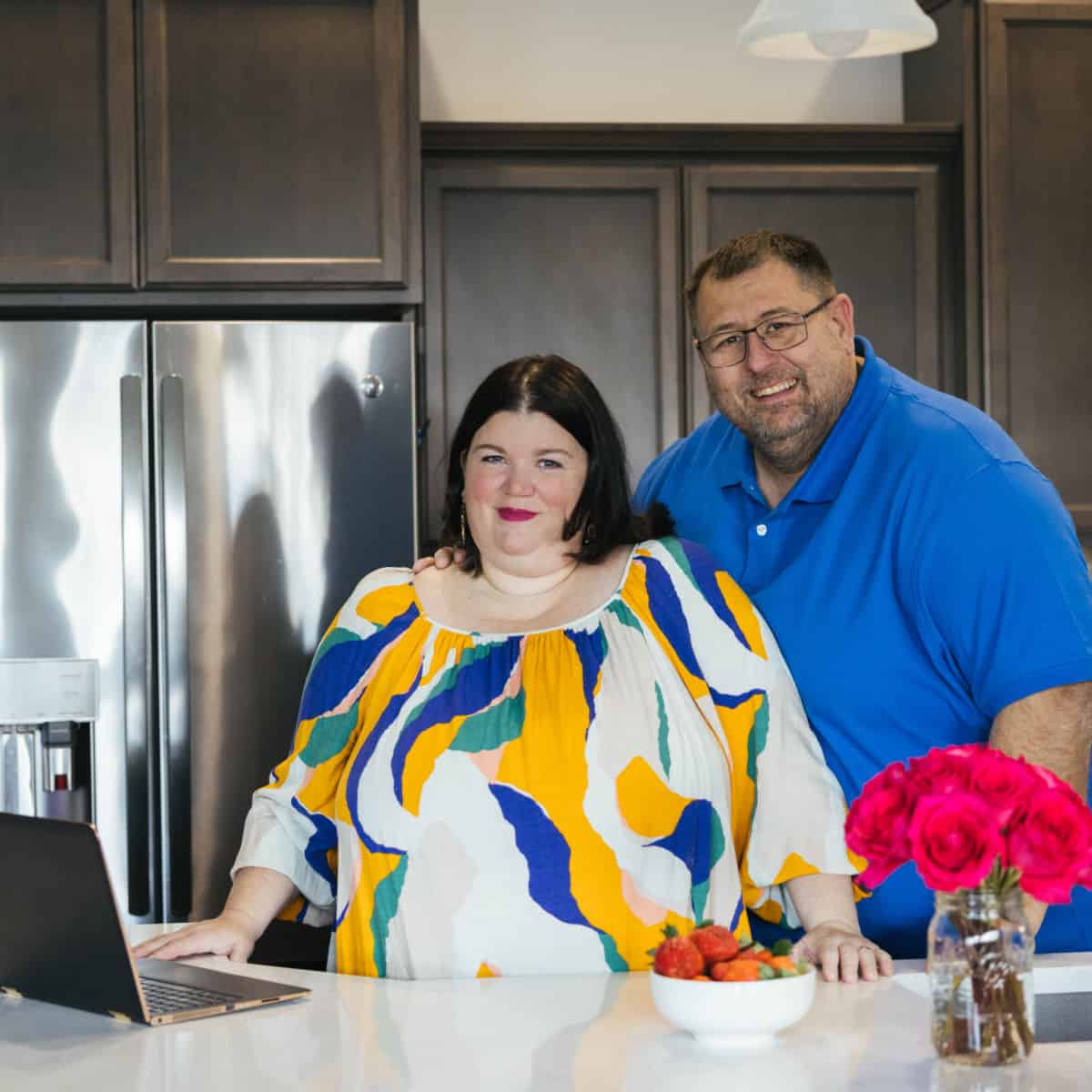 Tammilee and John in Kitchen next to laptop