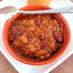 Wendy’s Chili in an orange bowl with a spoon on it