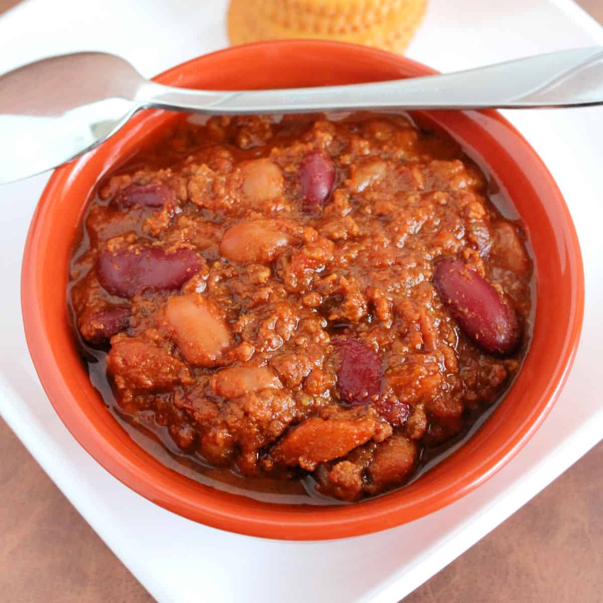 Wendy’s Chili in an orange bowl with a spoon on it