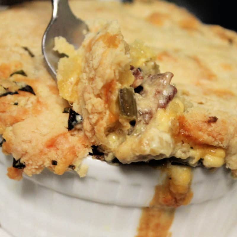 fork scooping bacon pot pie from a white ramekin