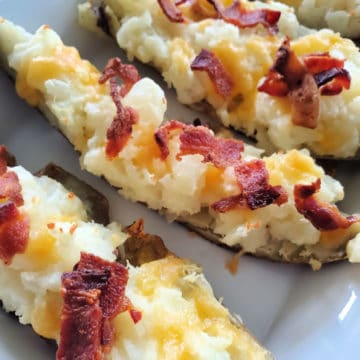 Cheese and bacon potato skins on a white platter