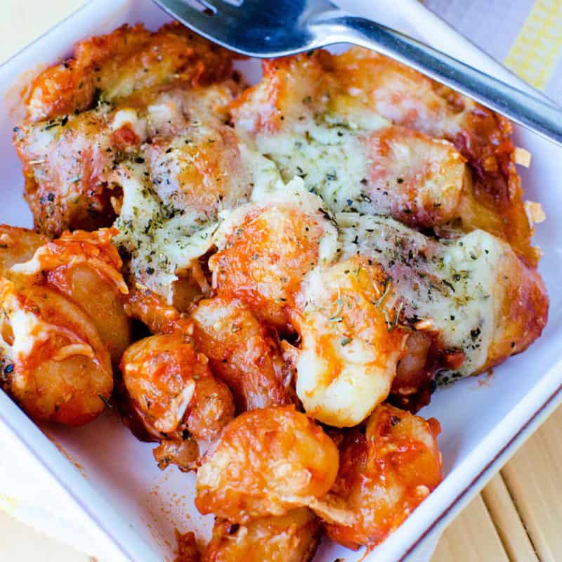 Gnocchi casserole in a white bowl with a fork 