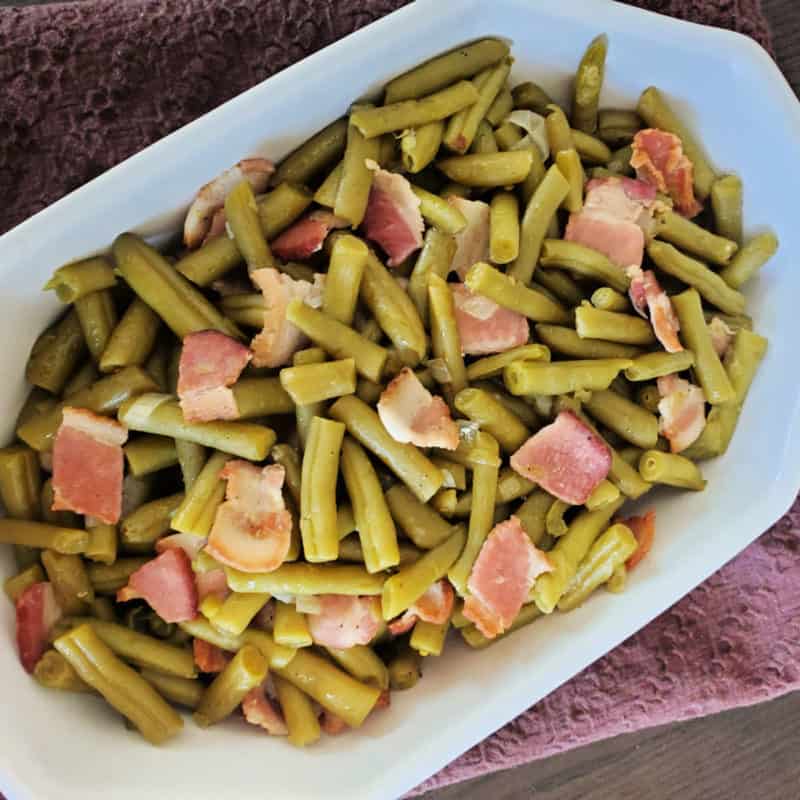Cracker barrel green beans and bacon in a white serving dish