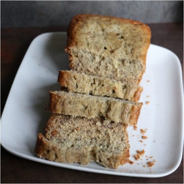 Slices of crockpot banana bread on a white plate