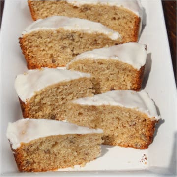 Slices of bourbon banana bread on a white platter