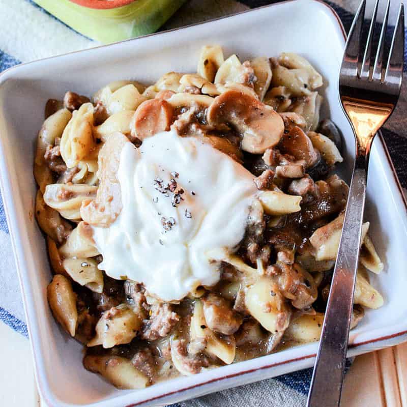 mushroom pasta in a white square dish with a fork