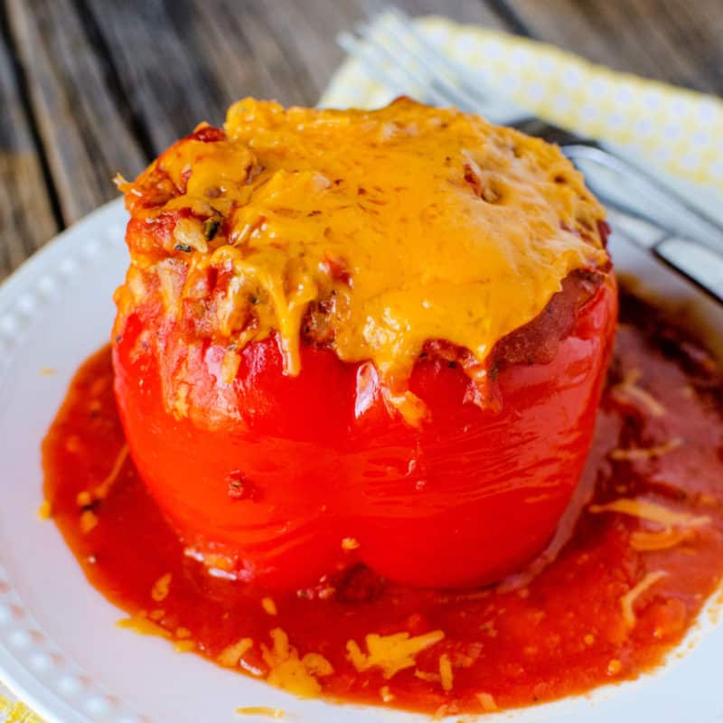 Crockpot Stuffed Pepper with cheese on a white plate next to a fork