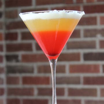 Candy Corn Martini with a brick background