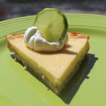 Margarita pie with a lime wheel on a green plate