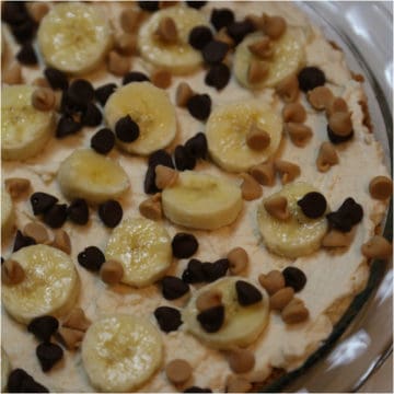 banana slices and chocolate chips on a no bake peanut butter pie