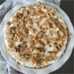 Nutter Butter Banana Pudding in a white pie dish with a cloth napkin