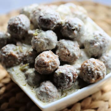 Swedish meatballs stacked in a white square dish