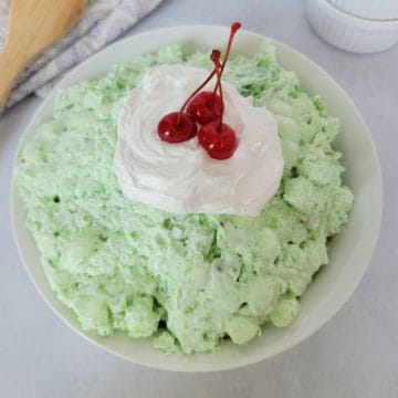 Green watergate salad with cool whip and maraschino cherries