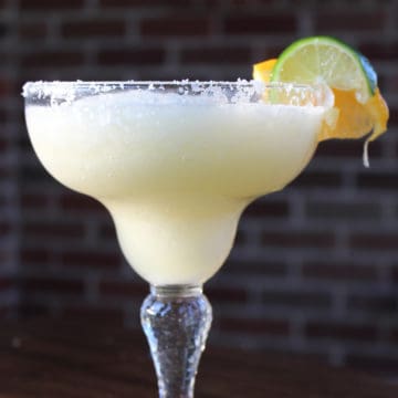 White Wine Margarita in a margarita glass with salt rim and lime wheel