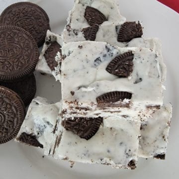 3-Ingredient Oreo Fudge stacked on a white plate next to Oreo Cookies