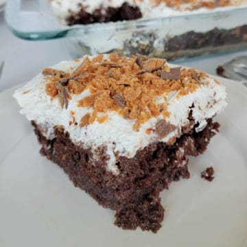 Square of butterfinger poke cake next to a cake pan