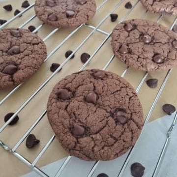 Chocolate Cake Mix Cookies on a wire rack with chocolate chips