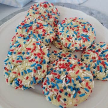Red, White, and Blue Cake Mix Cookies piled on a white plate