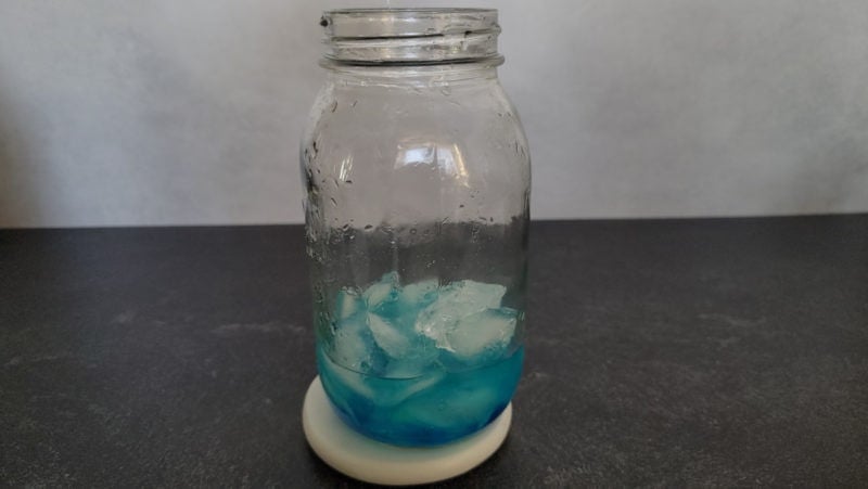 blue liquid with ice in a cocktail shaker