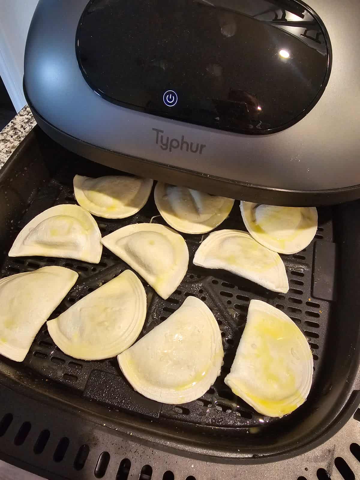 Pierogies with olive oil on them in the Typhur Air Fryer Basket