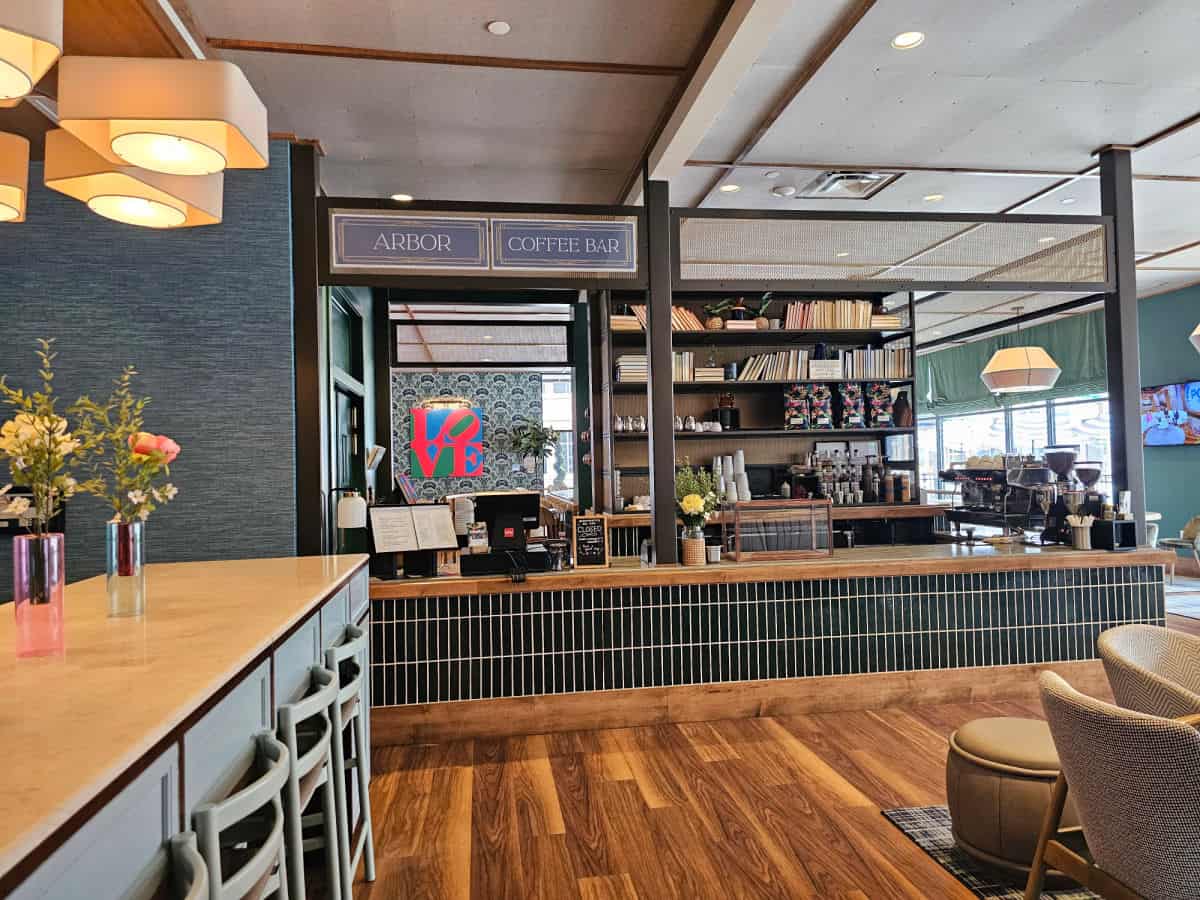 The Arbor Coffee Bar with long counter, LOVE Sign in the background, seating area