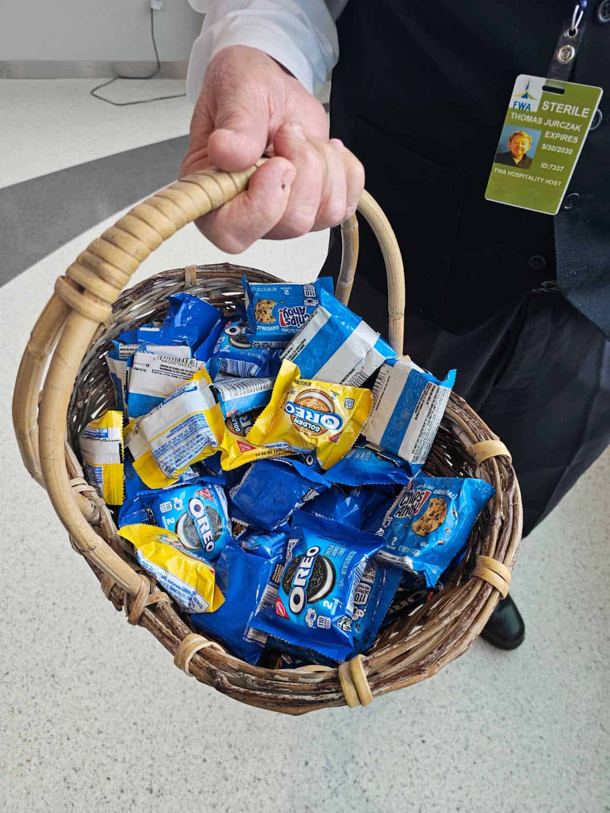 hand holding a basket of oreos