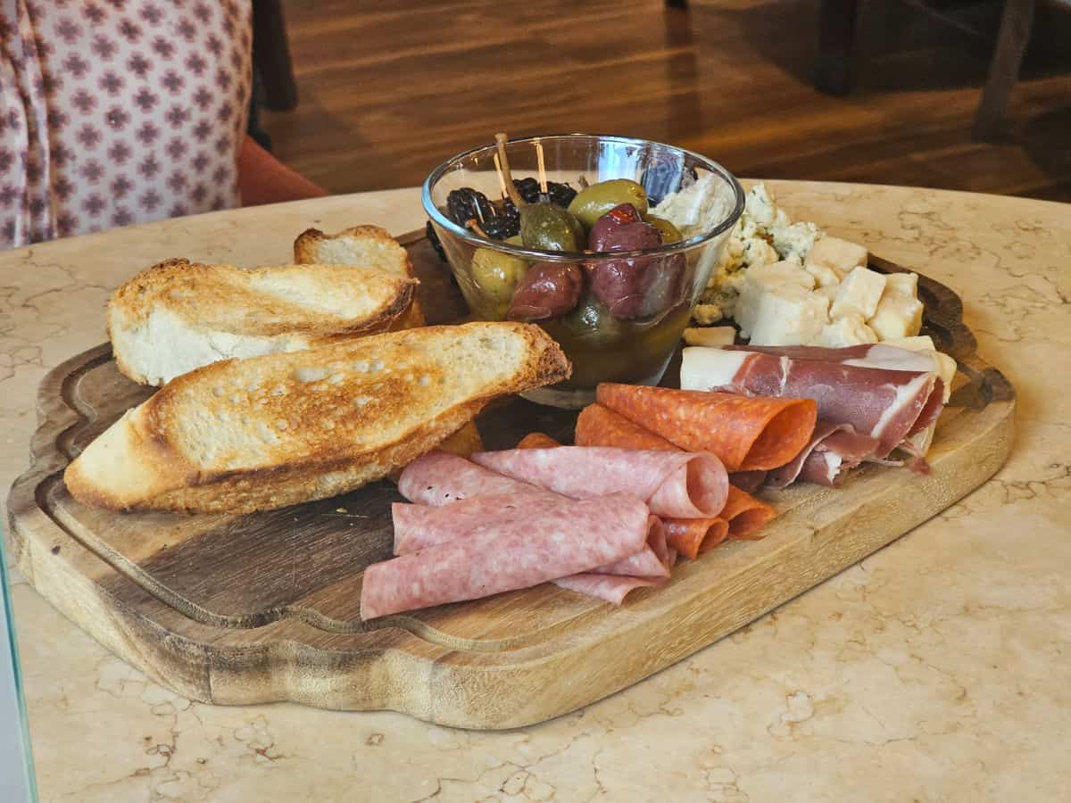 Charcuterie board with meat, cheese and bread