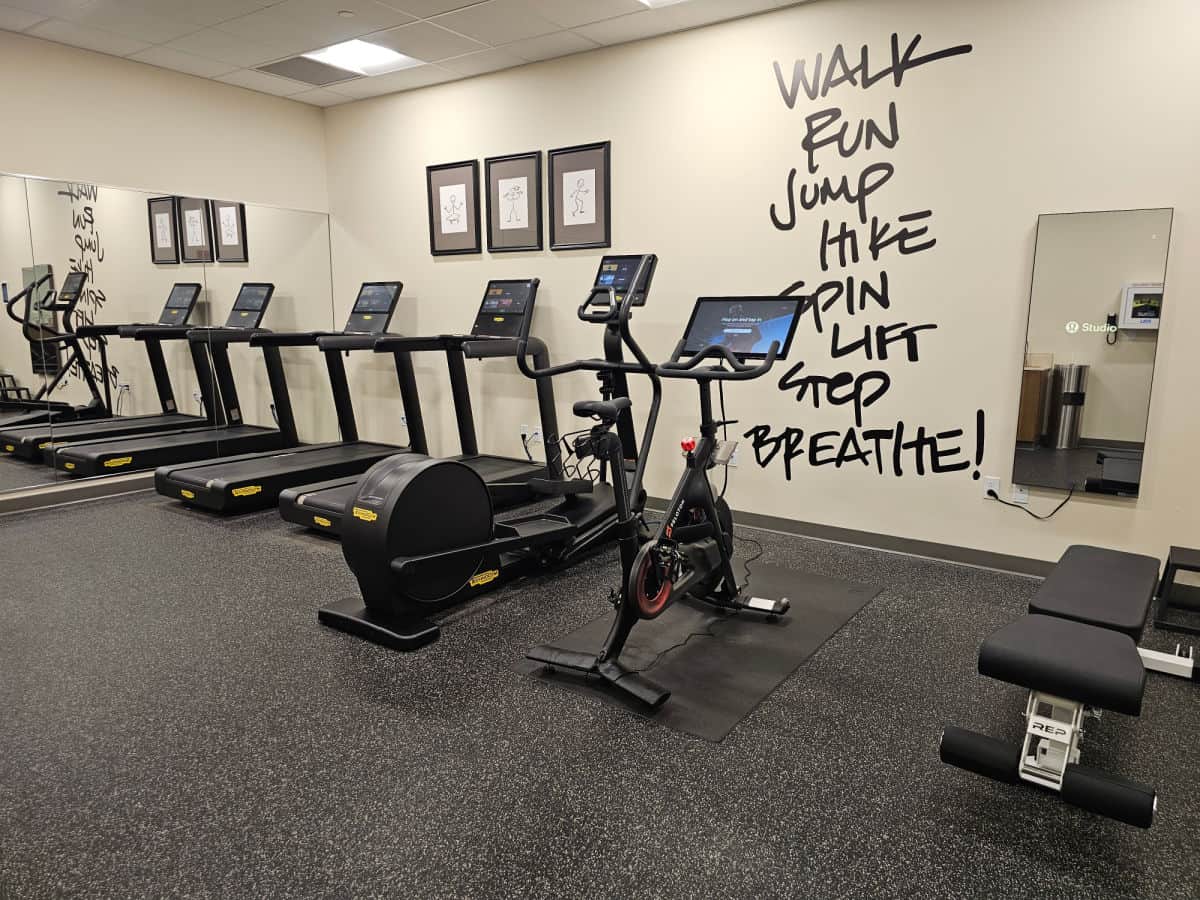 Fitness center with walk, run, jump, hike, life, step, breathe painted on the wall