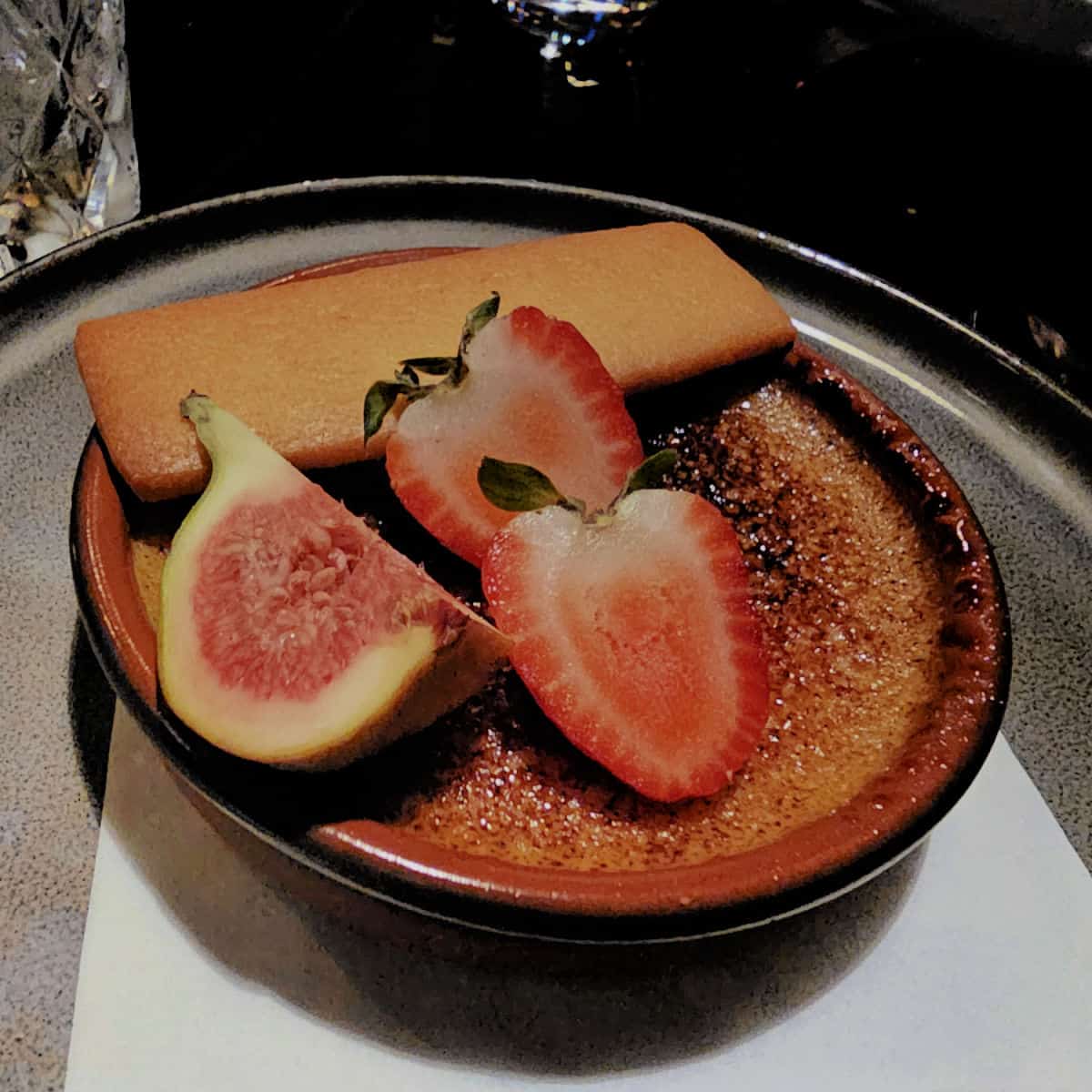 Maple creme brulee with strawberries and a fig with a maple cookie