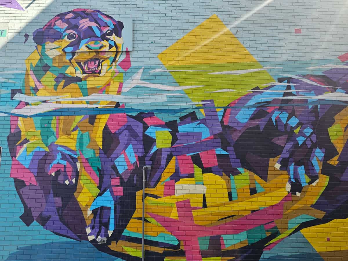 Abstract otter mural on a brick wall