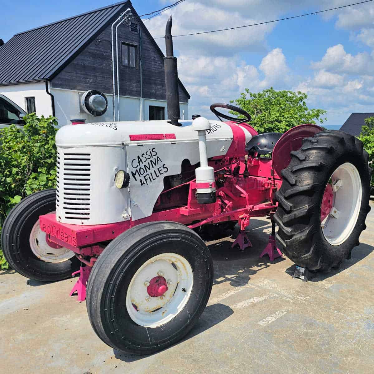 pink and white tractor with Cassis Monna & Filles painted on it
