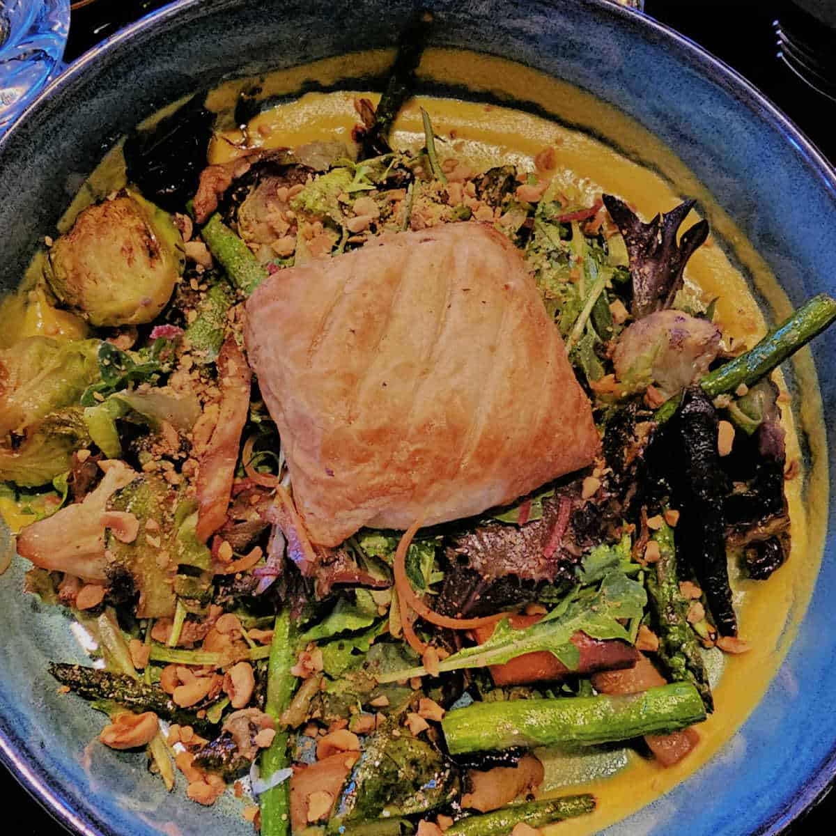 goat cheese encroute in the middle of a bowl with vegetables.