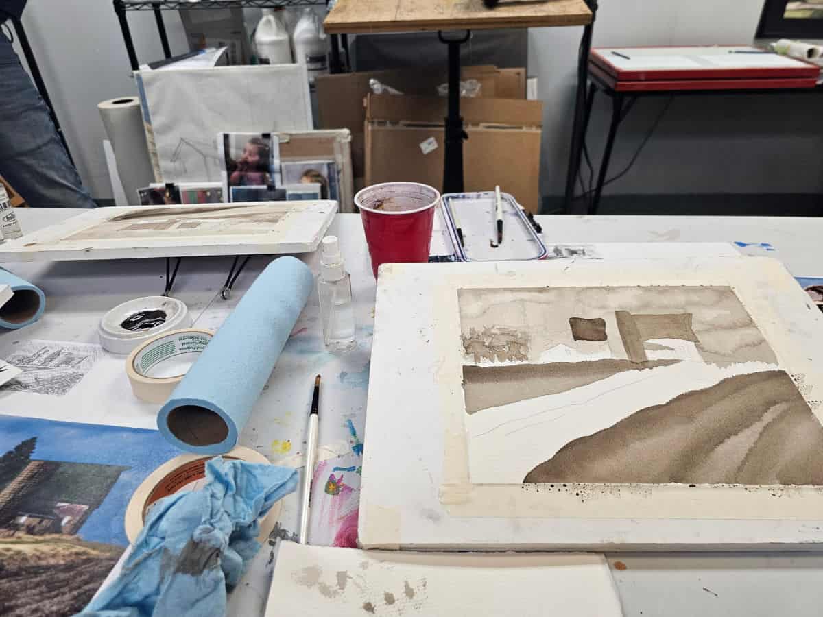 watercolor canvas on a table with paints and towels
