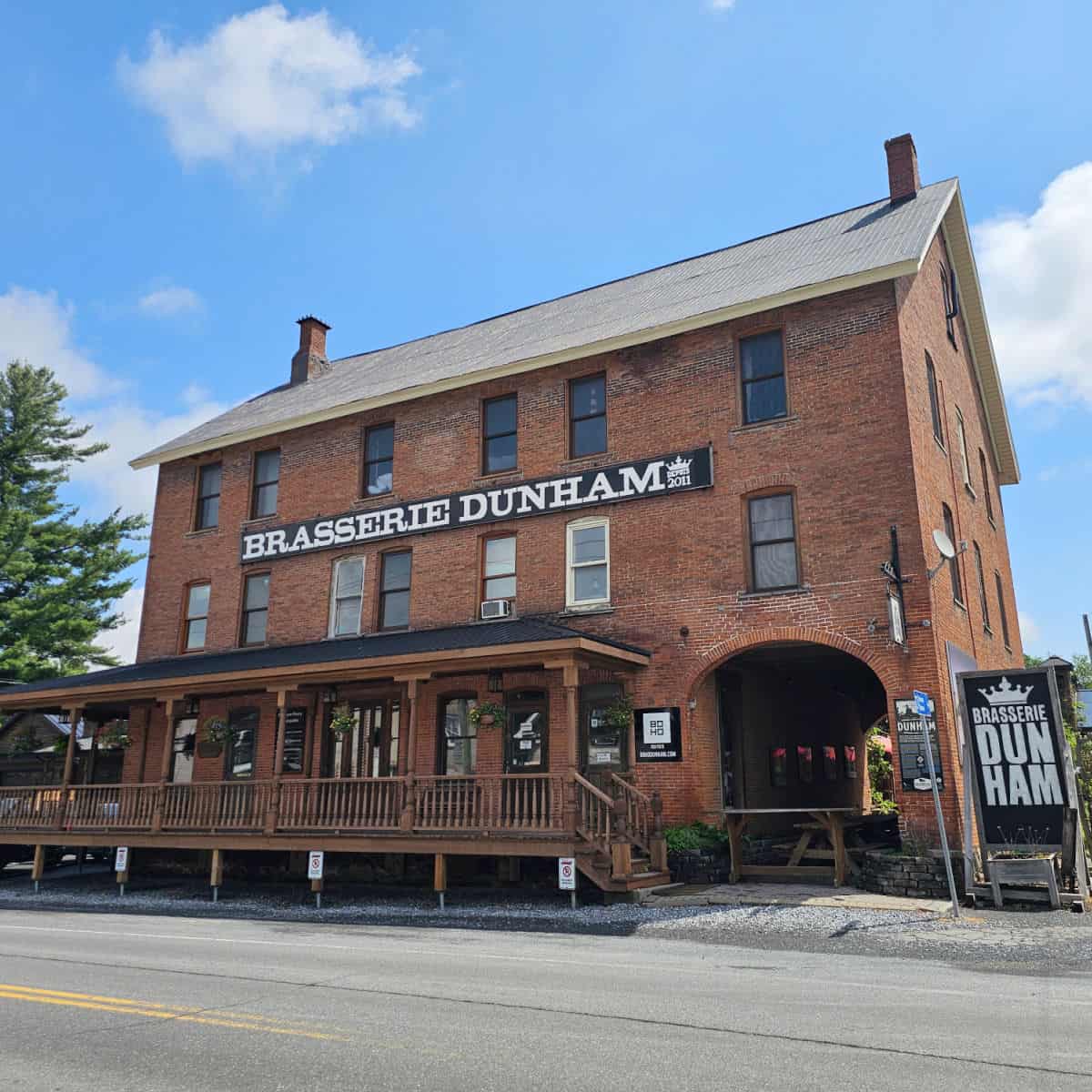 Brasserie Dunham brick building with large sign across the building
