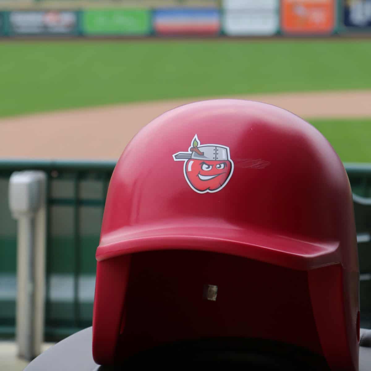 Red baseball hat with an apple wearing a tincap