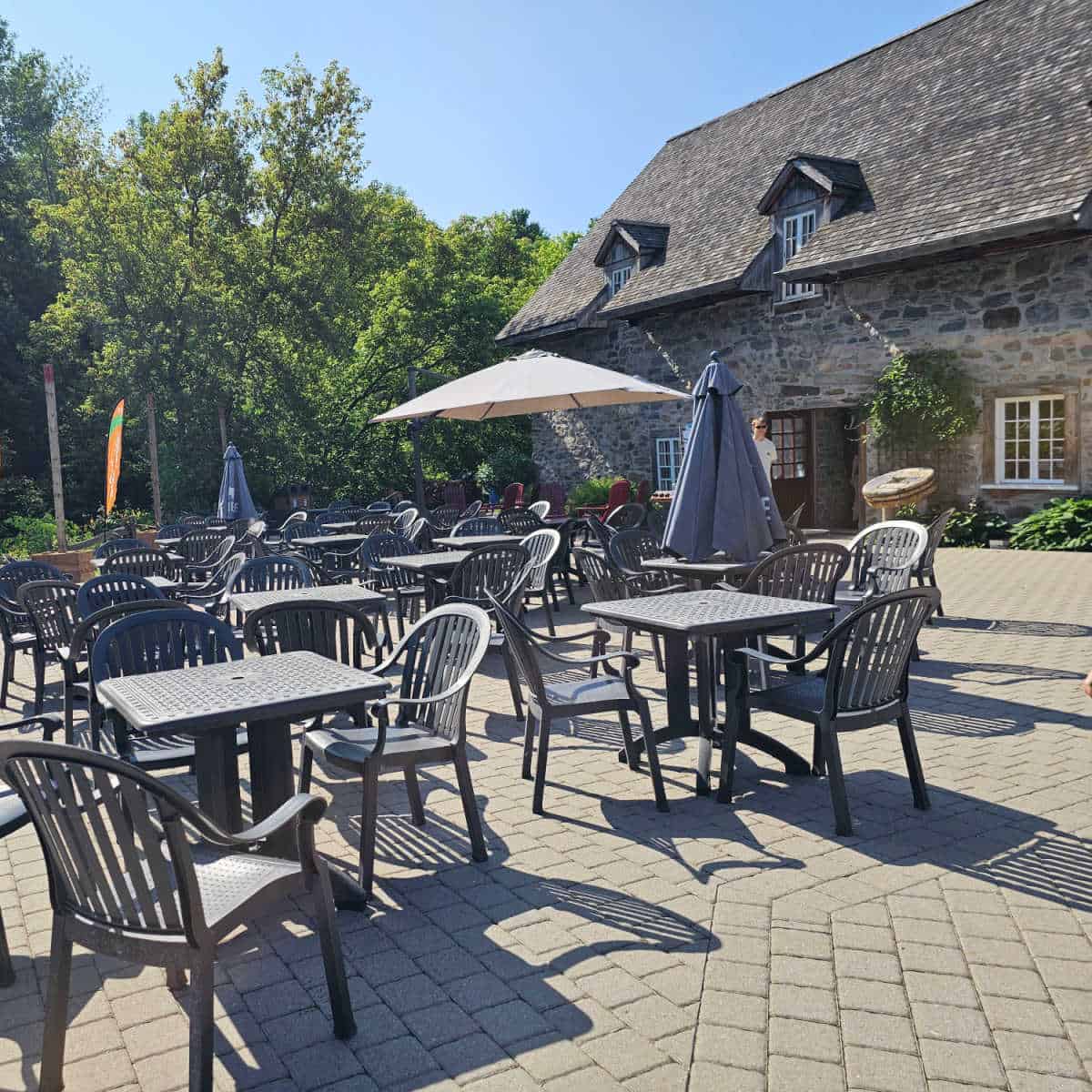 gorgeous patio in front of Moulin Michel with tables and chairs