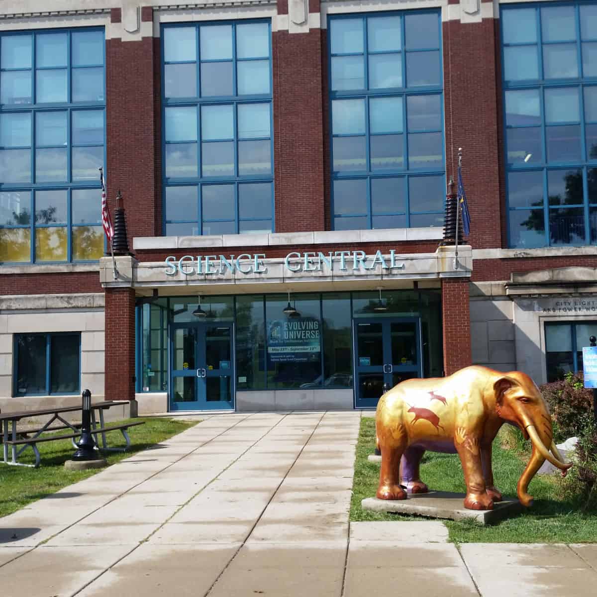 Science Central sign on a brick building with a golden elephant statue outfront.