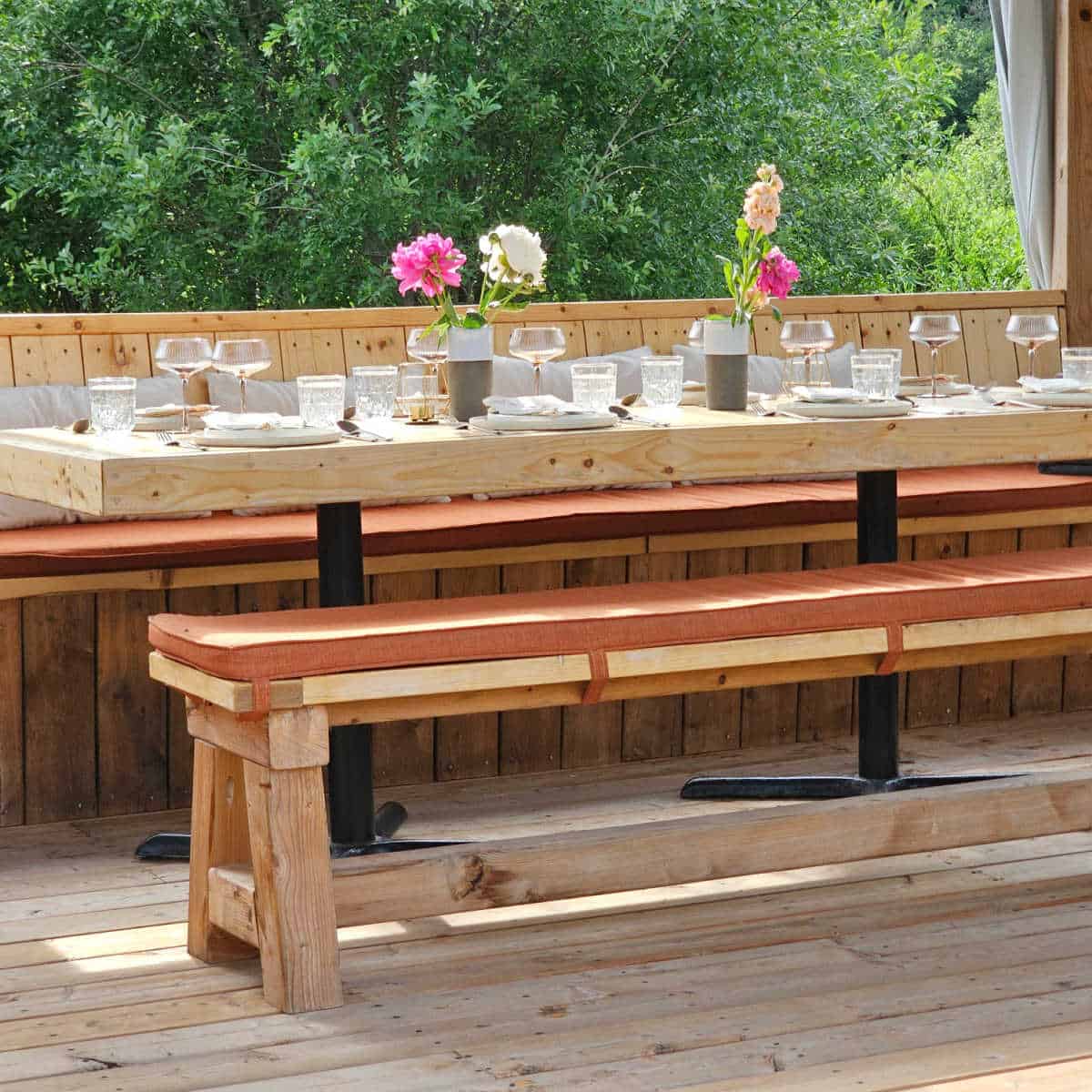 Wooden table with gorgeous flowers and place settings
