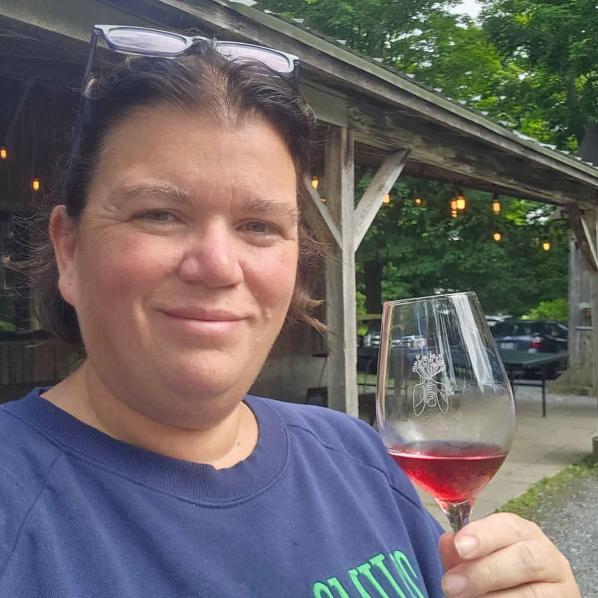 Tammilee holding a wine glass