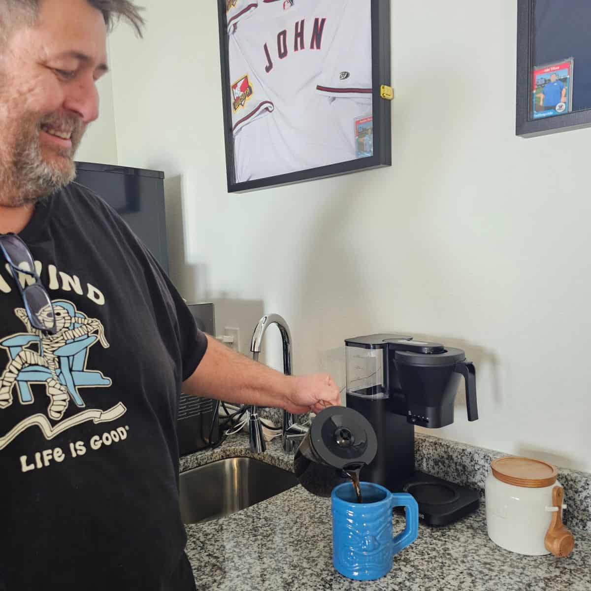 John pouring a cup of coffee from the Kismile Coffee Maker