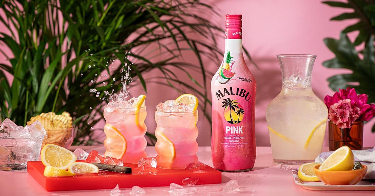 Malibu Pink bottle next to cocktails and lemonade