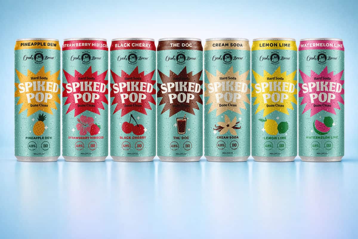 Cans of spiked pop lined up with a blue background