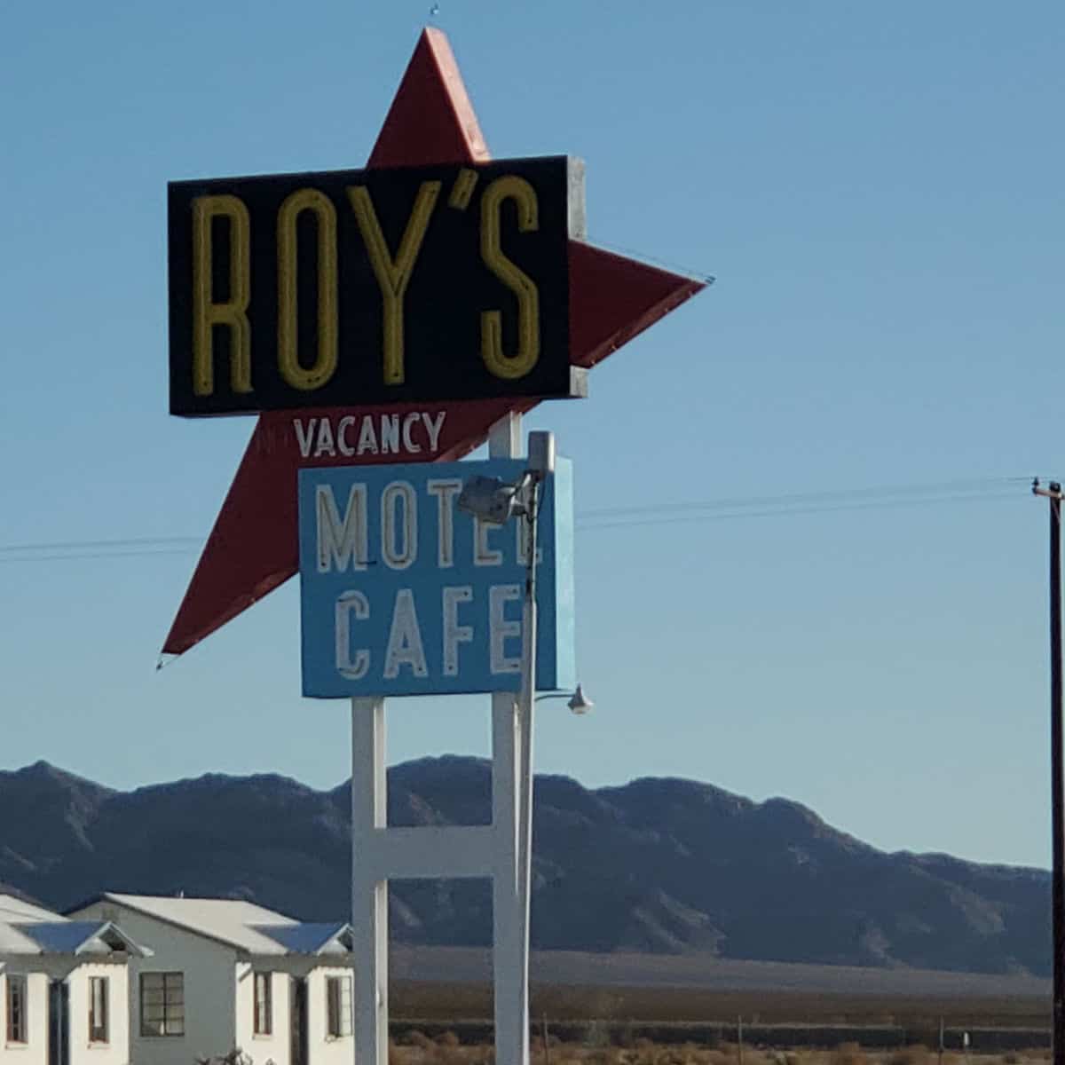 Roy's Motel Cafe hotel sign along Route 66 on a blue sky day